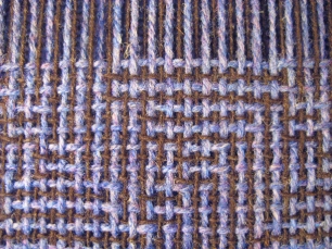 Shadow weave in woolen yarns - close-up of weaving in progress on the loom before wet finishing